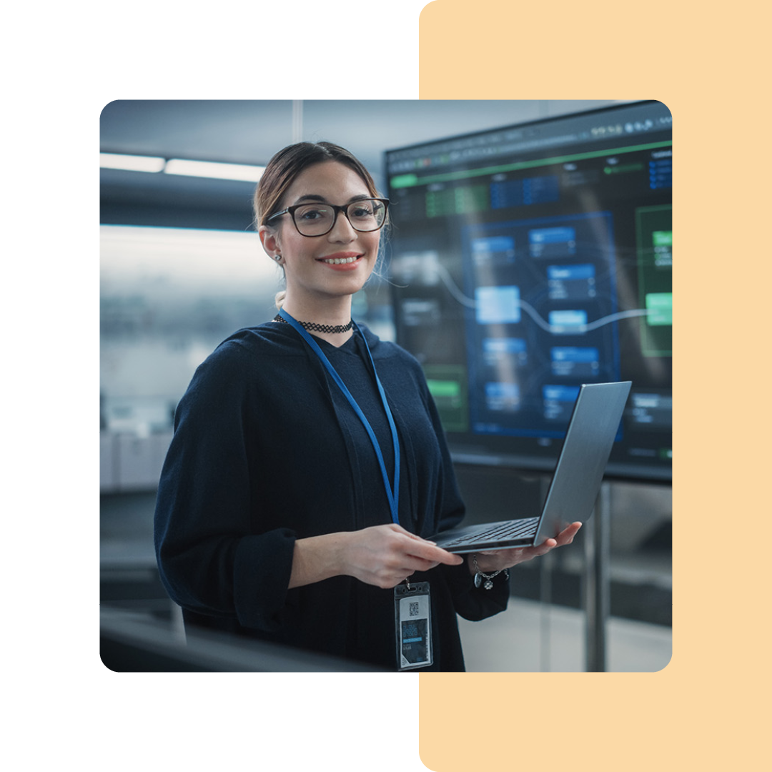 Image of a cyber security professional stood holding a laptop