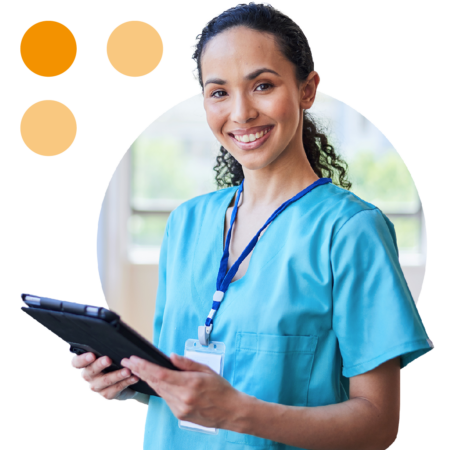 Image of a smiling doctor stood holding a tablet