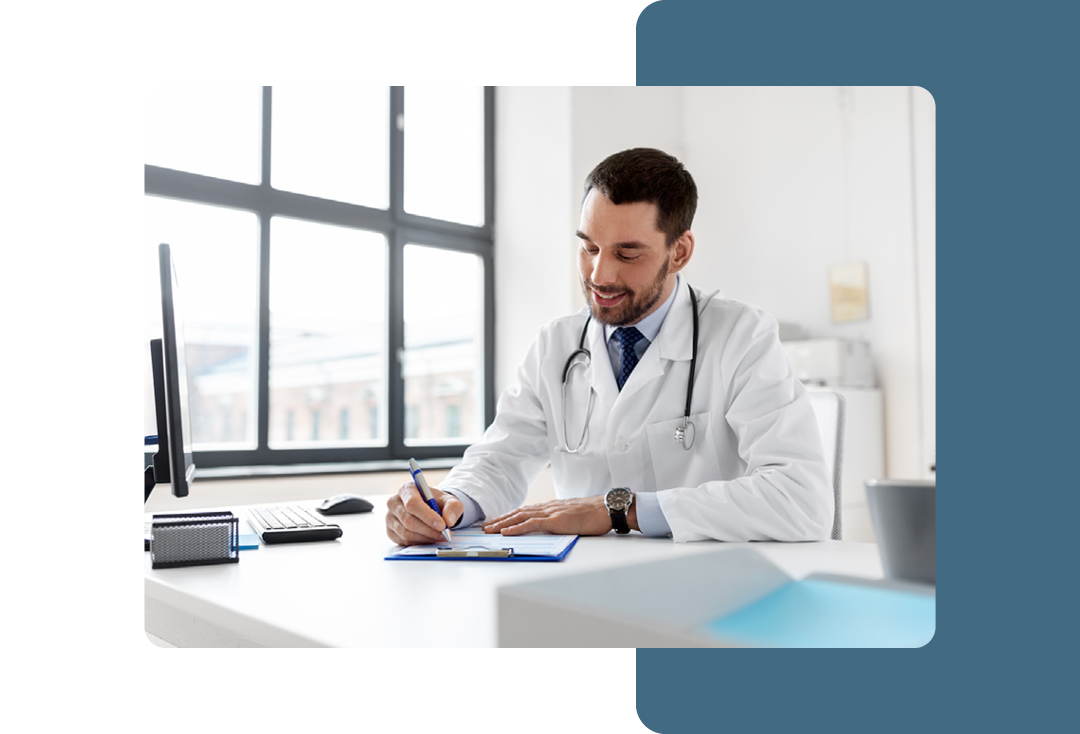 Image of a doctor working at a desk writing on a clipboard