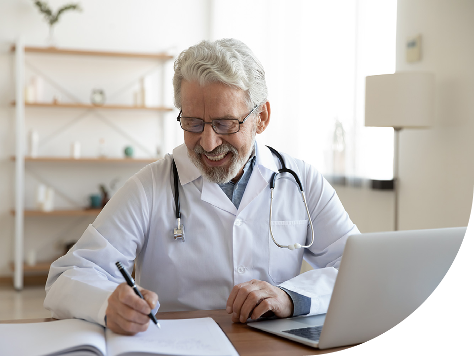 Image of a smiling doctor writing in a notepad