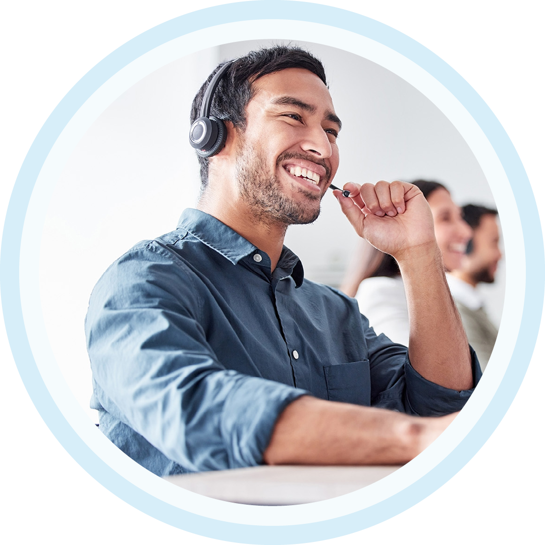 Image of an IT support professional working on a computer with a headset on