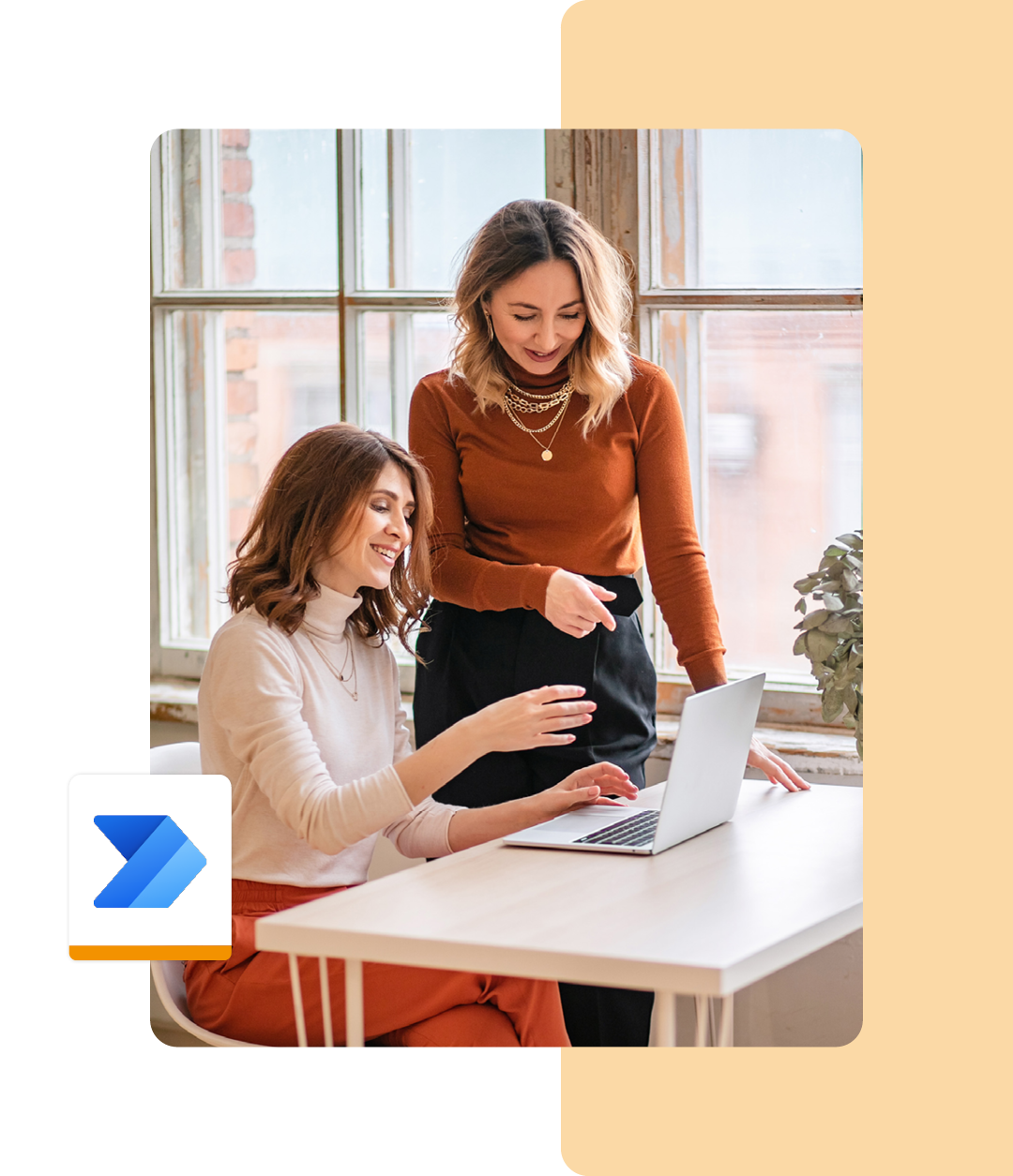 Image of two colleagues working together on a laptop