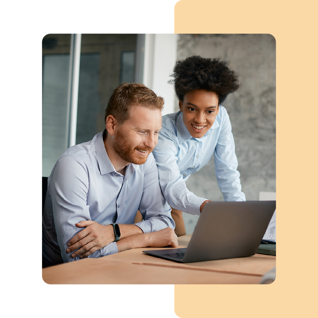 Image of two business professionals working on a laptop together