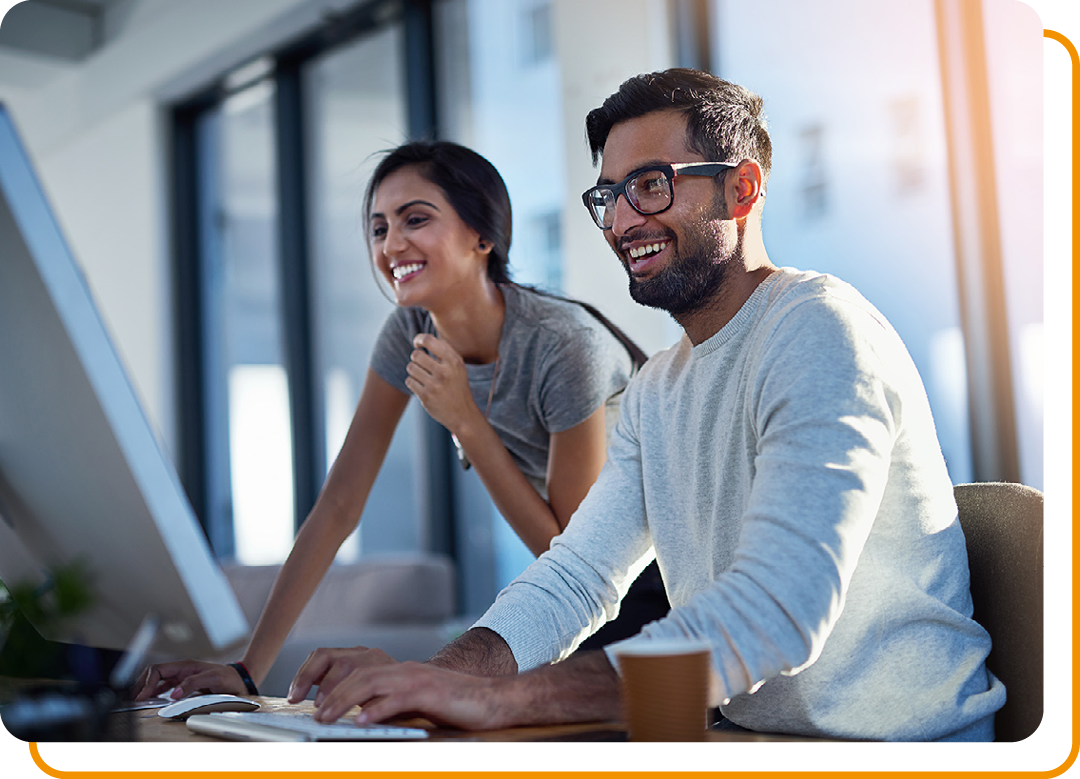 Image of two business professionals working together on a laptop