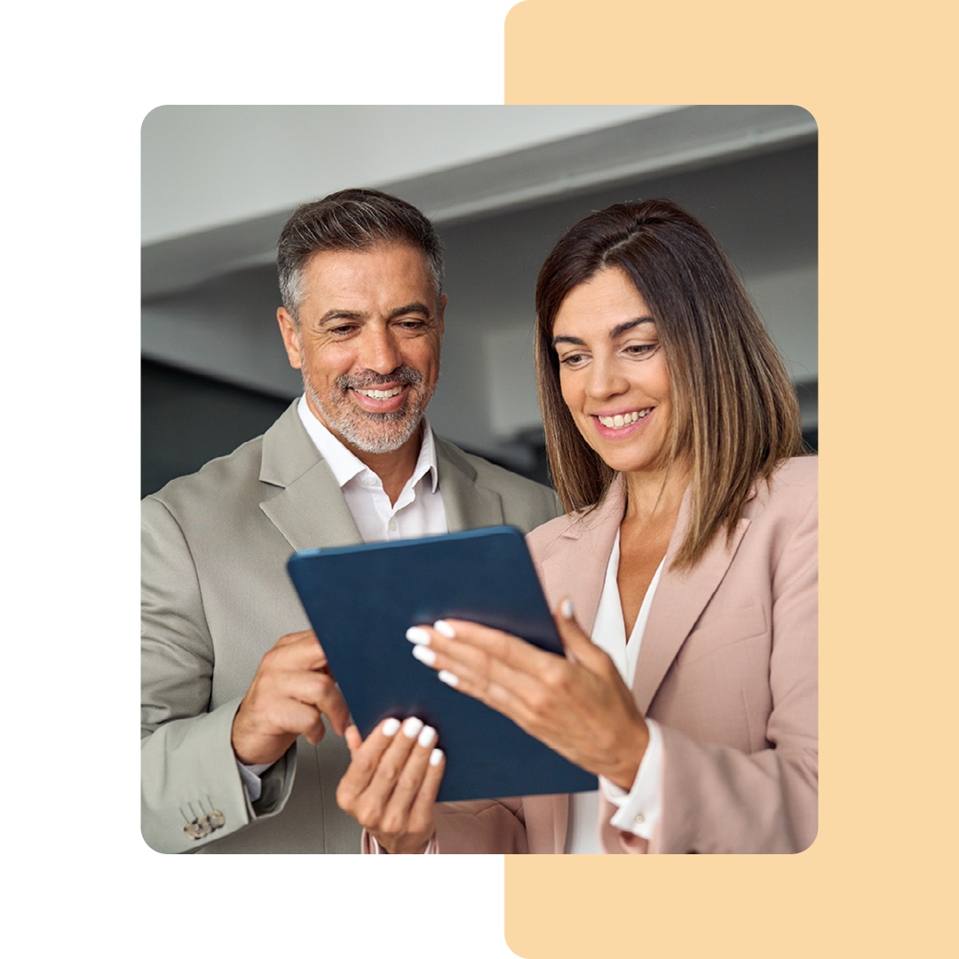 Image of two colleagues working together on a tablet