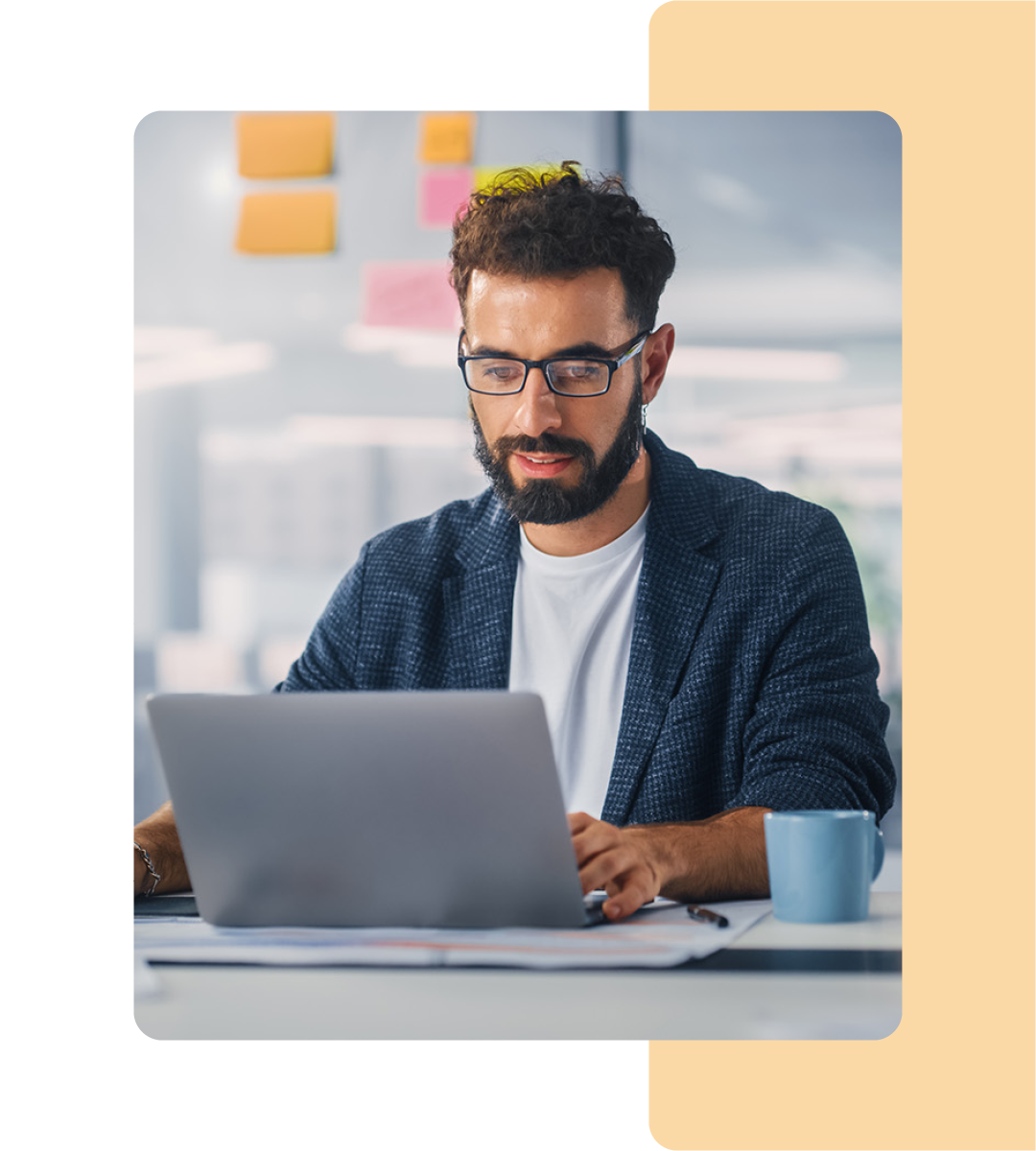 Image of a person working on a laptop in an office environment