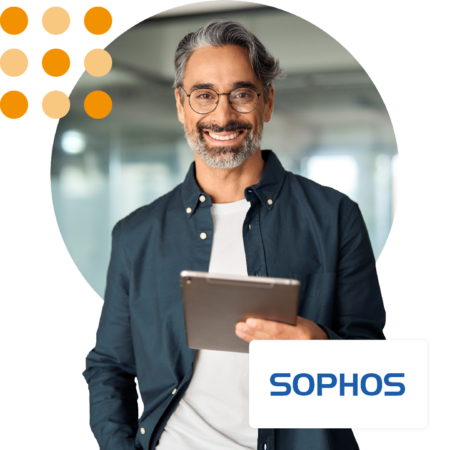 Image of an IT professional stood in an office holding a tablet with the Sophos logo