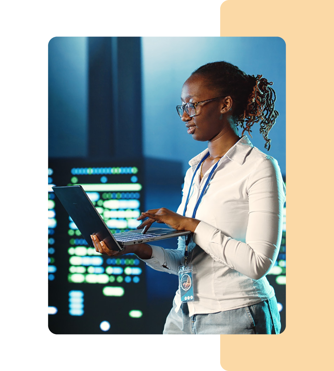 Image of an IT professional walking in a server room holding a tablet