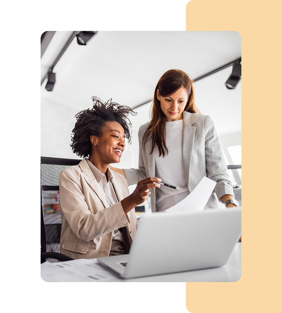 Image of two business professionals working on a laptop