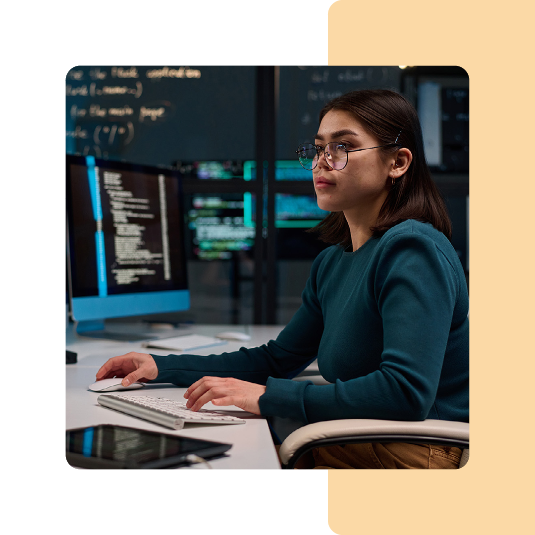 Image of an IT professional sat at a desk working on a computer