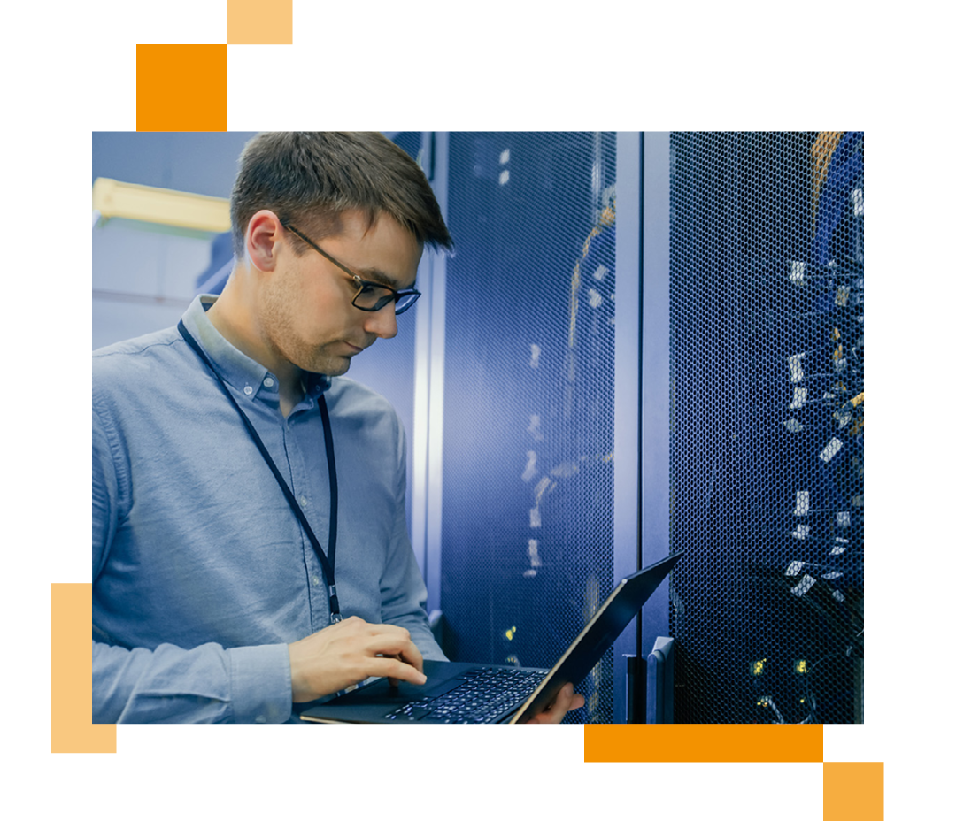 Image of an IT professional stood in a server room