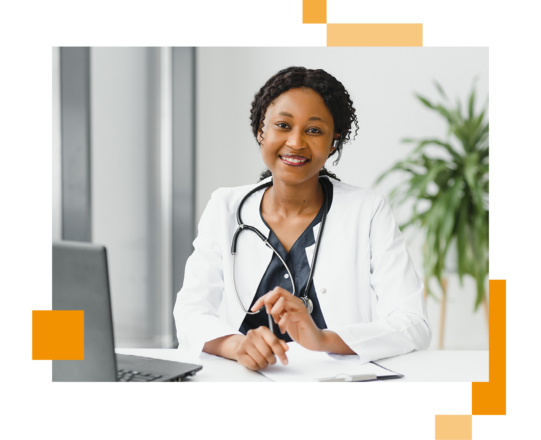 Image of a smiling doctor working at a desk