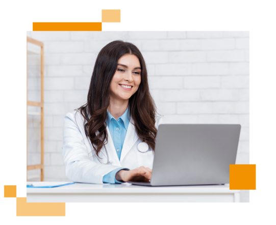 Image of a smiling doctor working on a laptop