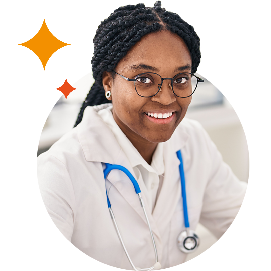 Image of a smiling doctor sat at a desk