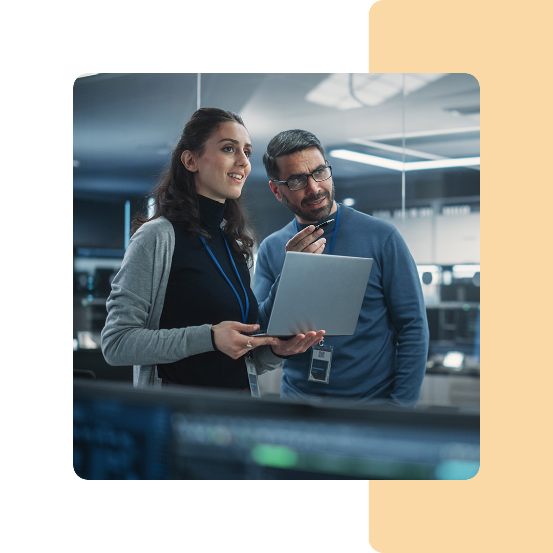 Image of two IT professionals in conversation in a server room