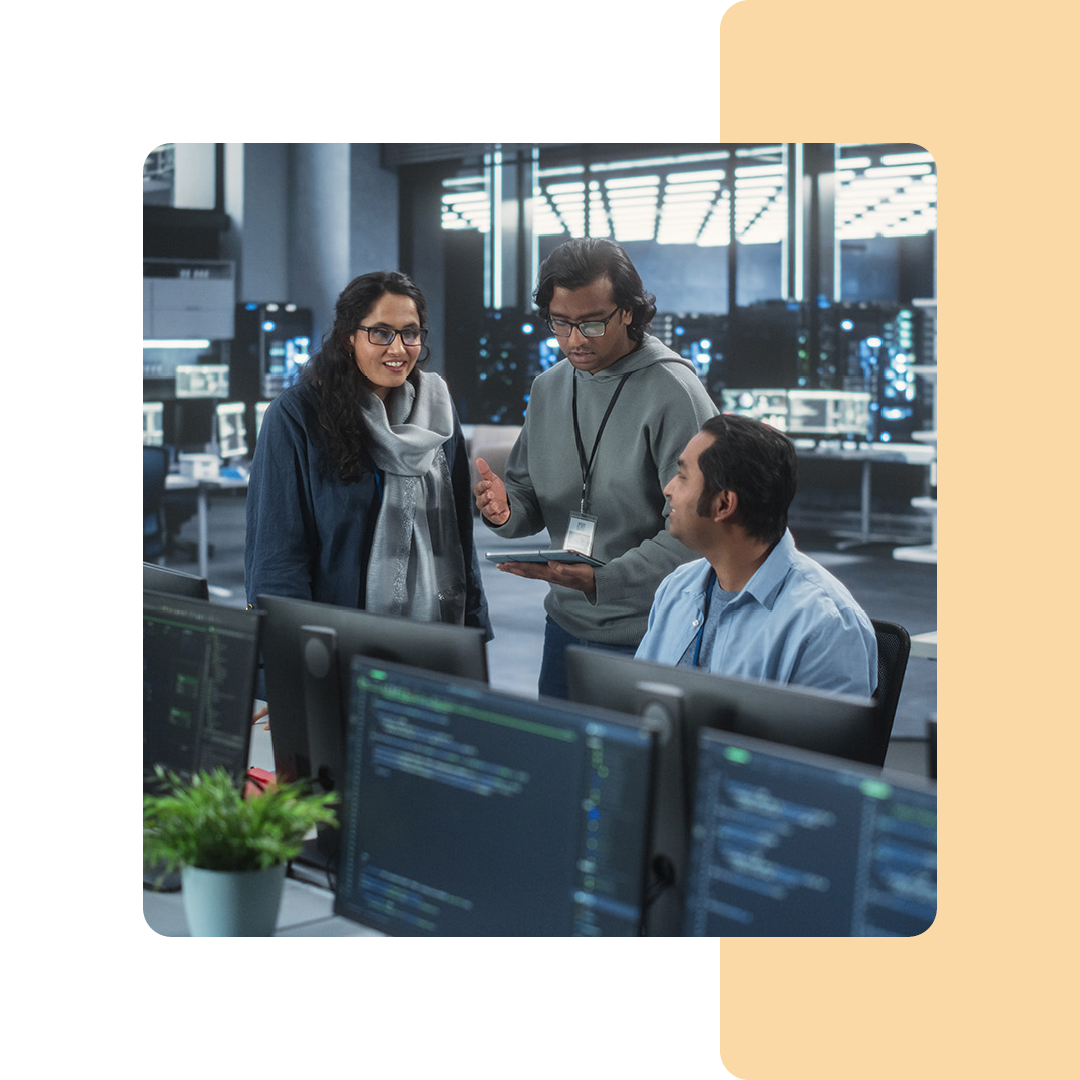 Image of three IT professionals in conversation in an office