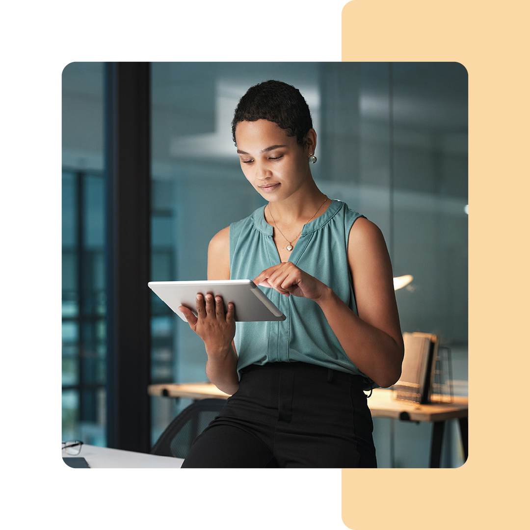 Image of an IT professional stood holding a tablet