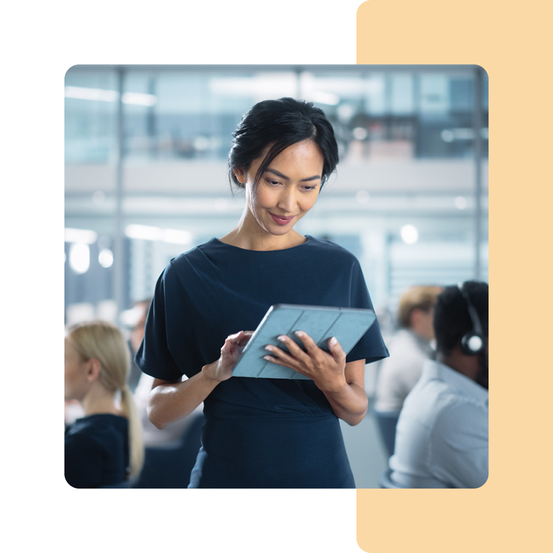 Image of an IT professional stood holding a tablet