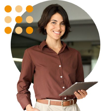 Image of an IT professional stood in an office holding a tablet