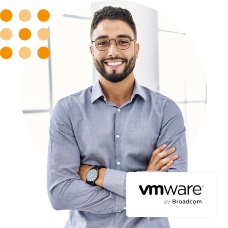 Image of a smiling business professional stood in an office environment with the VMware by Broadcom logo