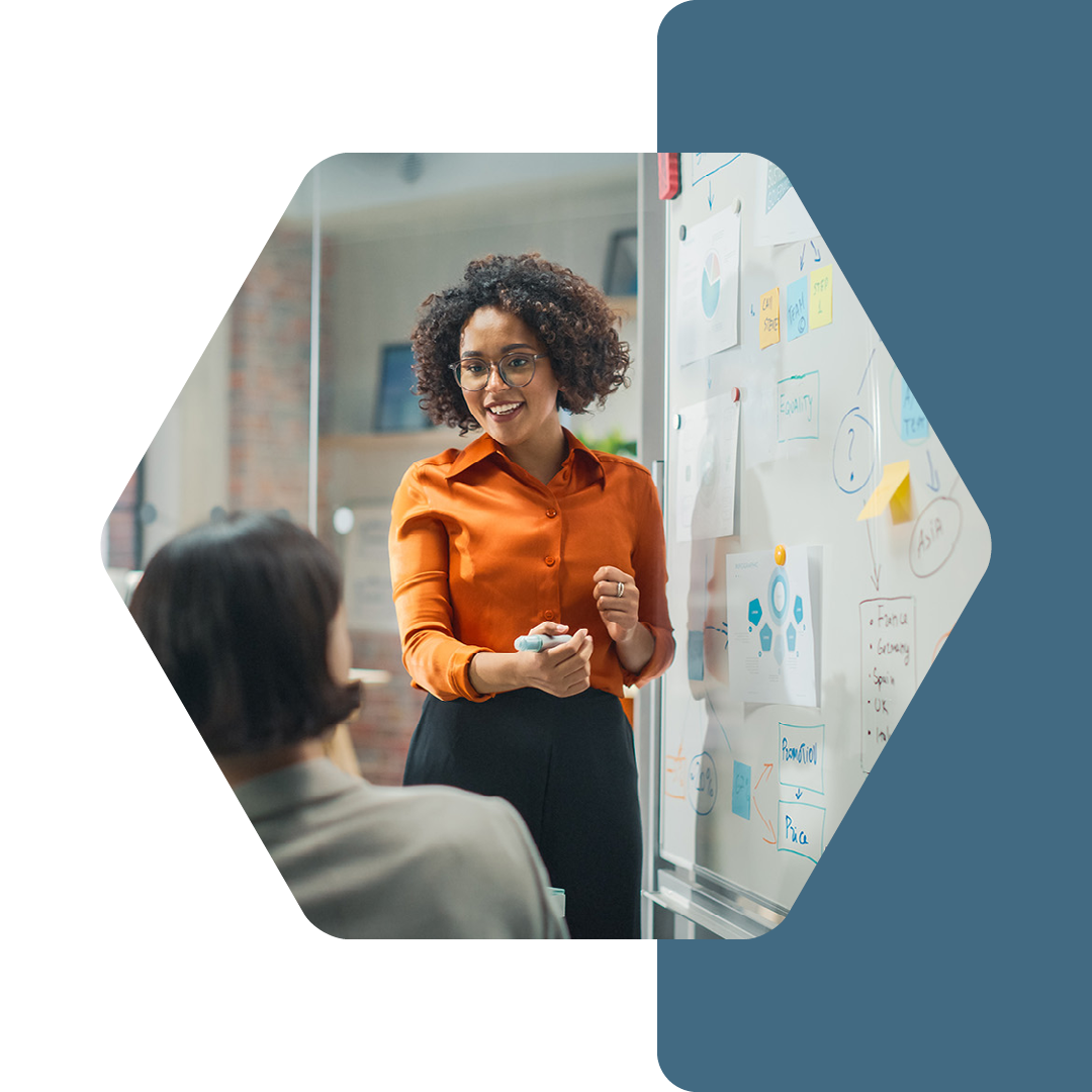 Image of a security professional talking to a group of people while writing on a whiteboard