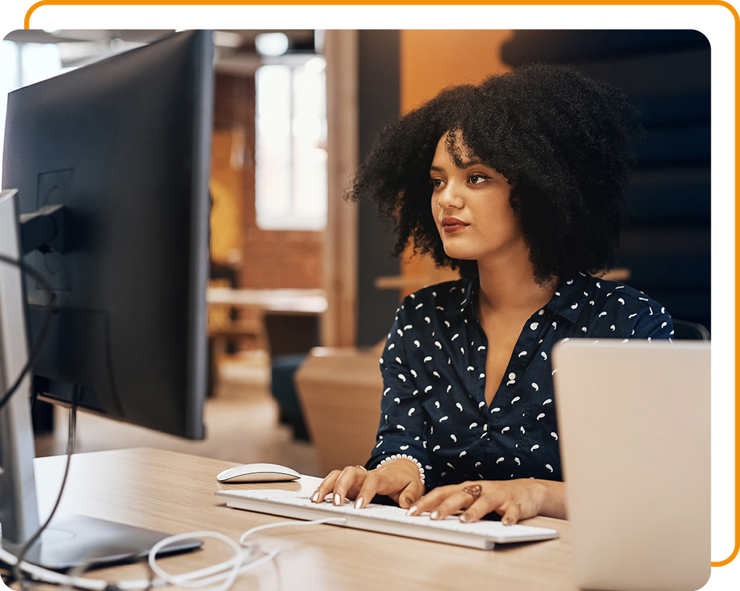 Image of a person working on a computer in an office