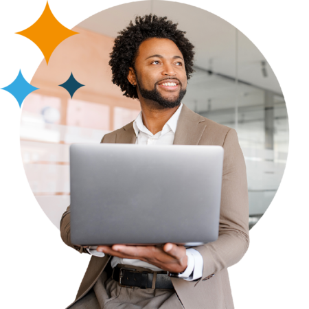 Image of a smiling business professional stood holding a laptop