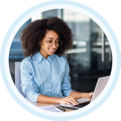 Image of a smiling person working on a laptop