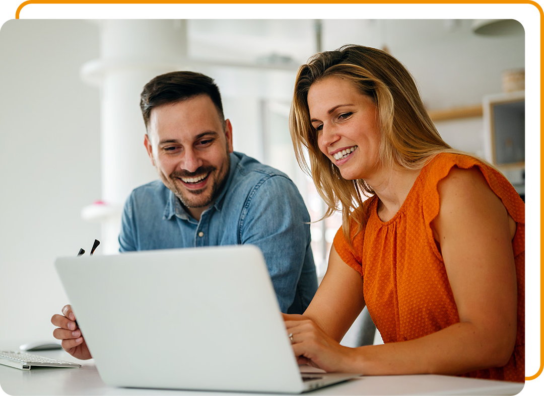 Image of two colleagues working together on a laptop