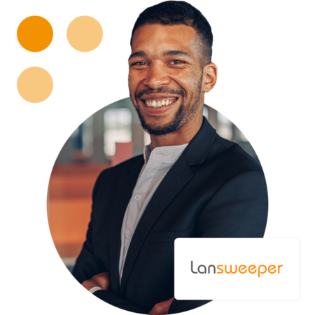 Image of a smiling business professional stood in an office environment with the Lansweeper logo