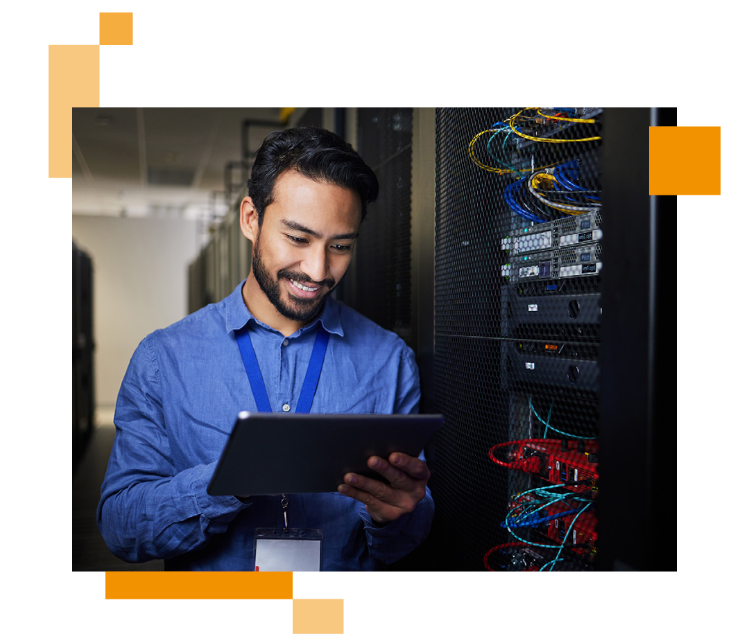 Image of an IT professional working on a tablet in a server room