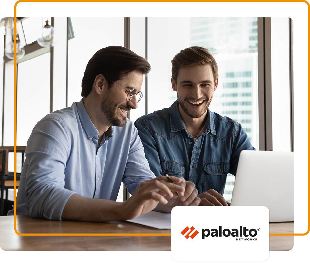 Image of two colleagues sat conversing and working on a laptop with the Palo Alto logo