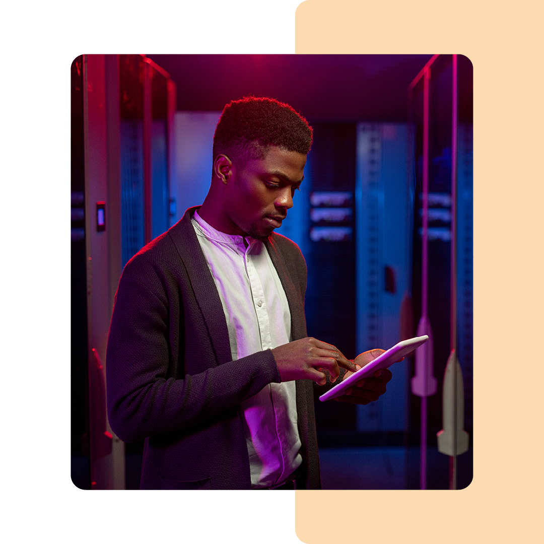 Image of an IT professional working on a tablet in a server room