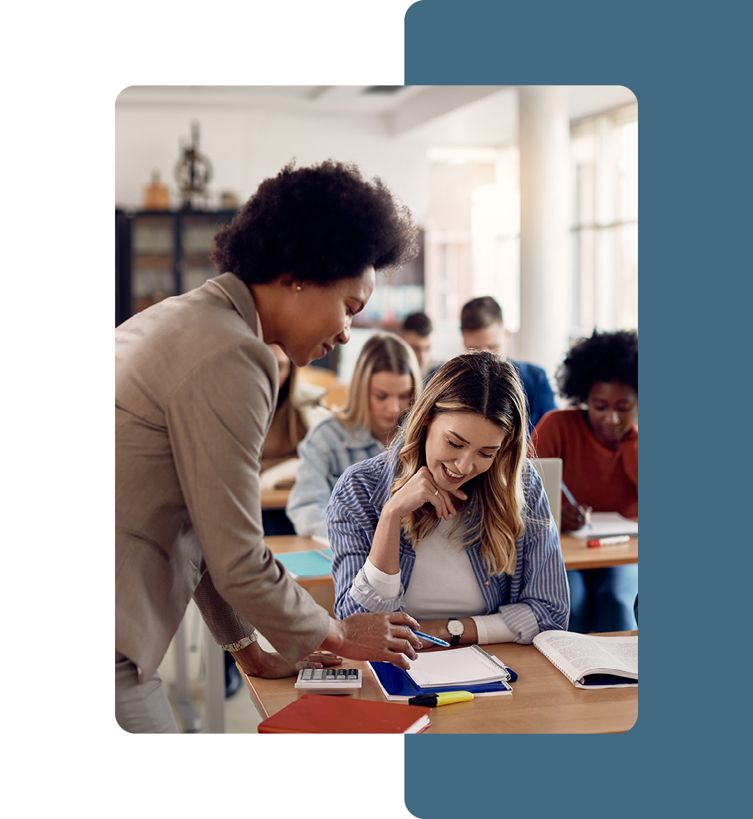 Image of a teacher talking to a student in a classroom