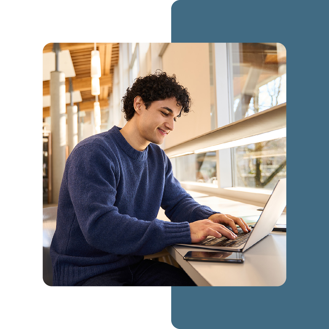 Image of a university student working on a laptop