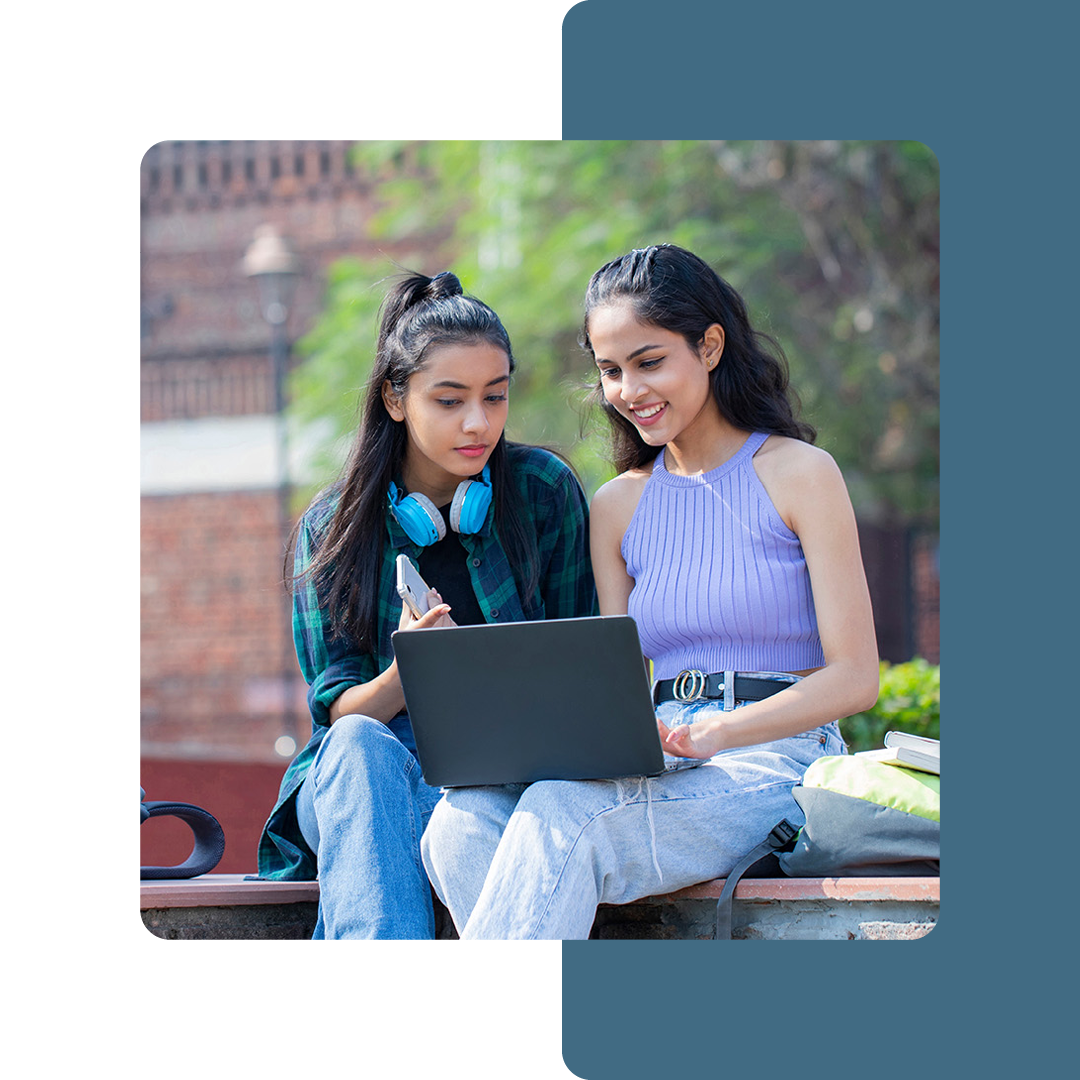 Image of two university students working on a laptop