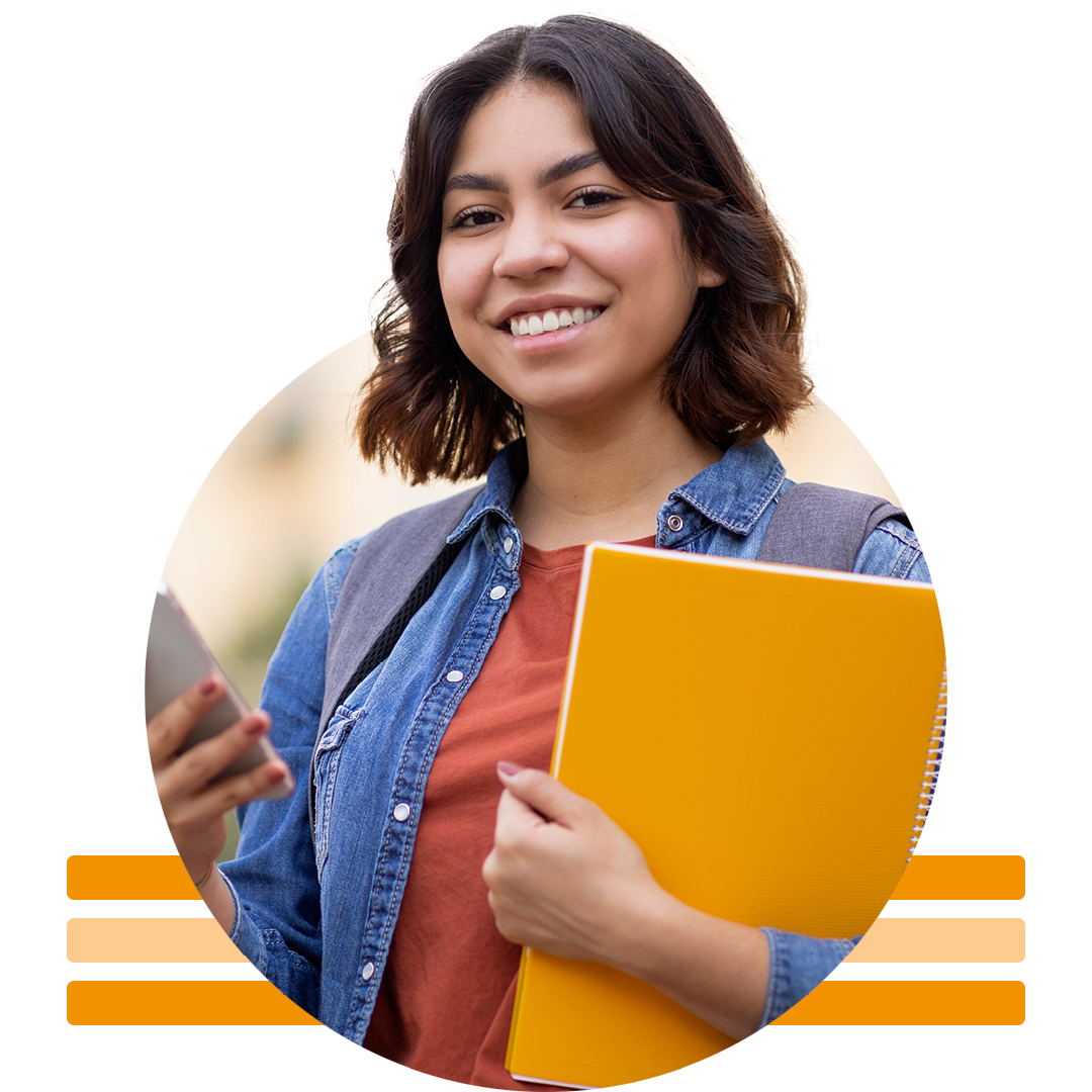 Image of a smiling university student holding notebooks