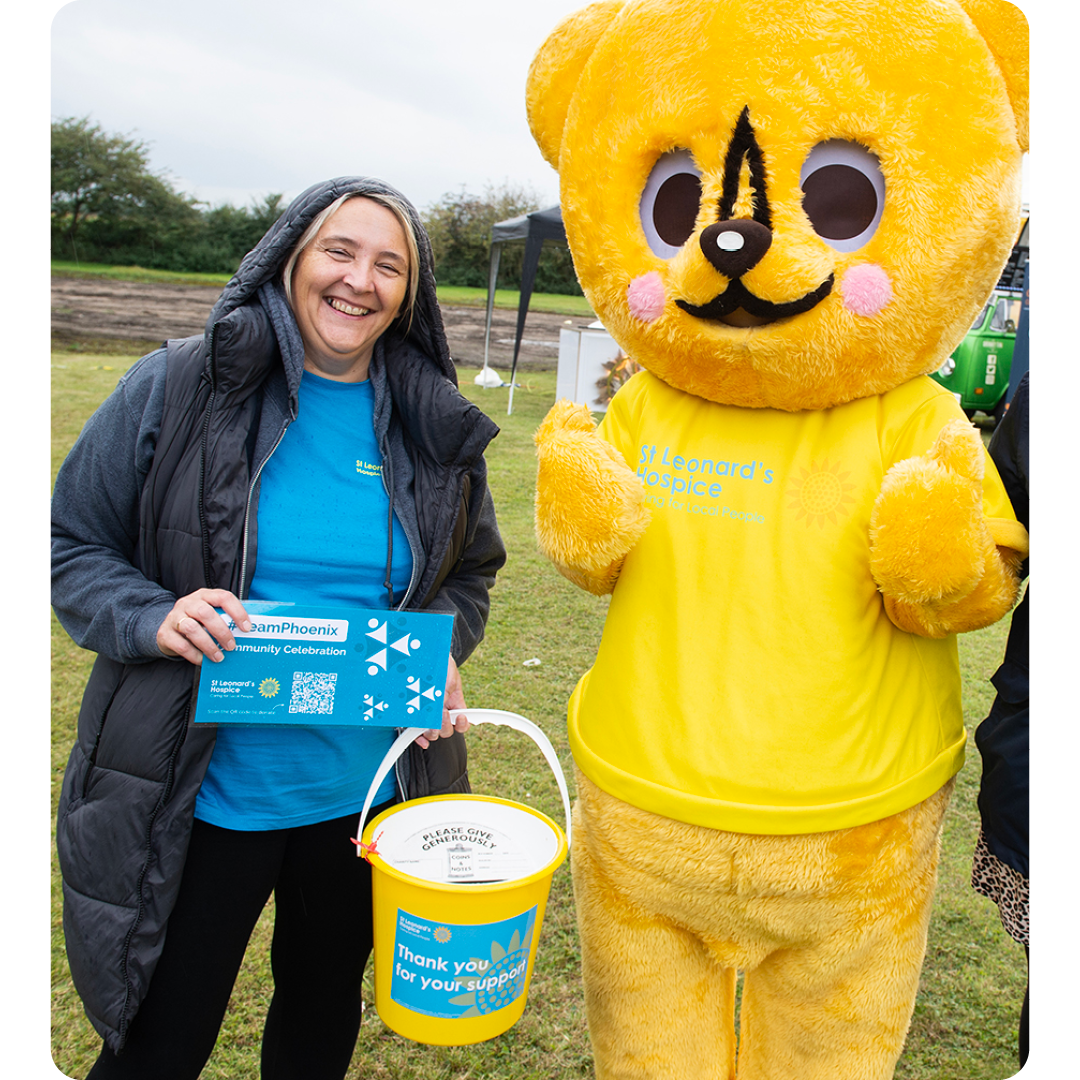 Image of a Phoenix Software employee with the St Leonards Hospice mascot at a Community Event