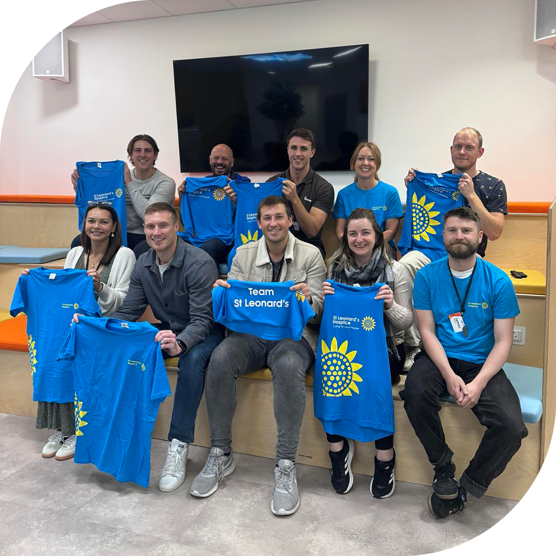 Image of a group of Phoenix Software employees holding a St Leonards Hospice t-shirt