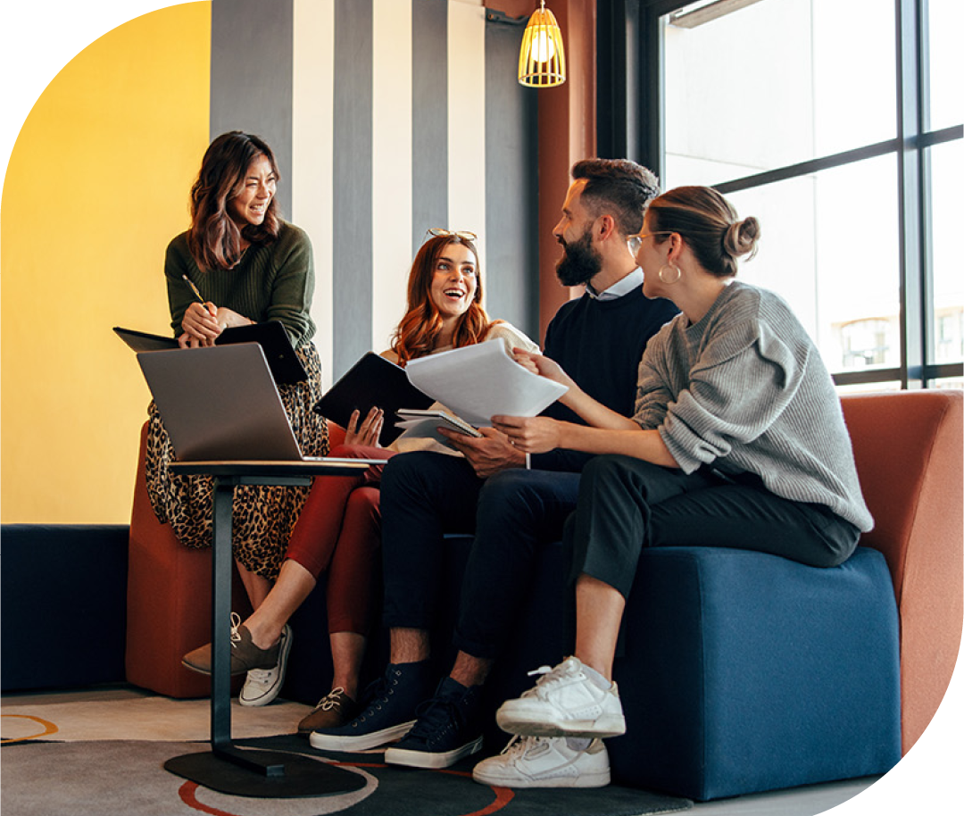 Image of a group of colleagues talking in an office environment