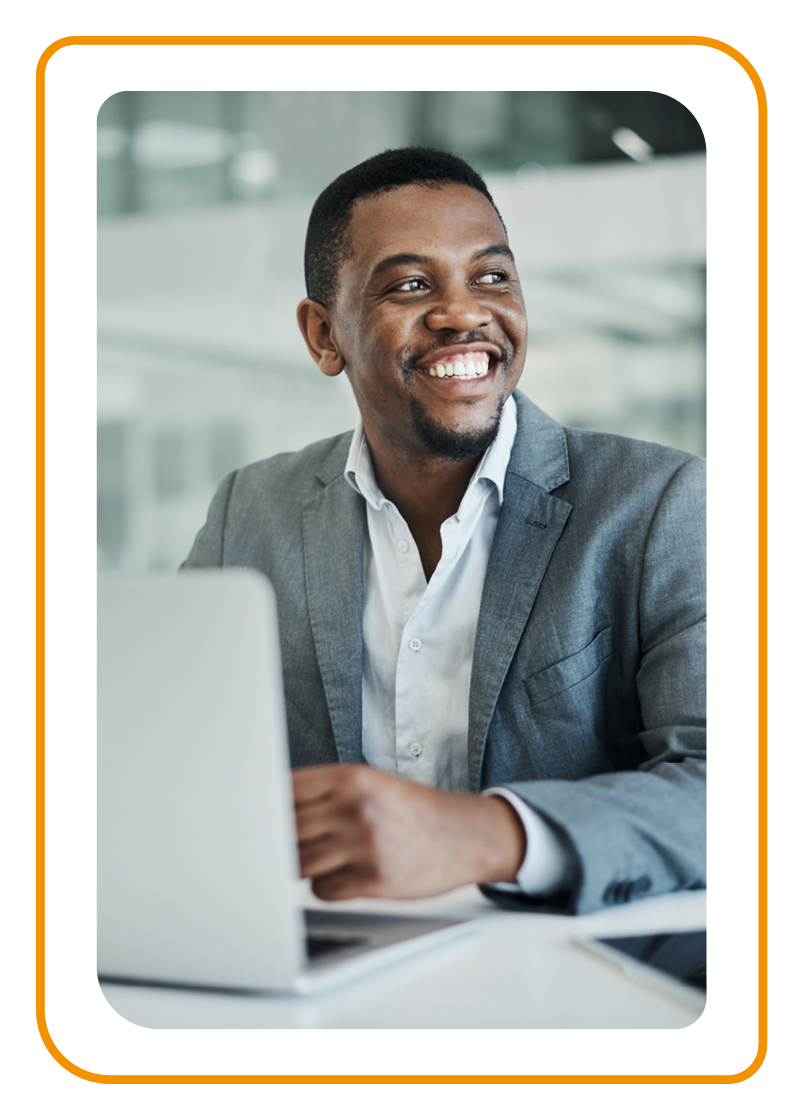 Young businessman sitting alone in his office and using his laptop