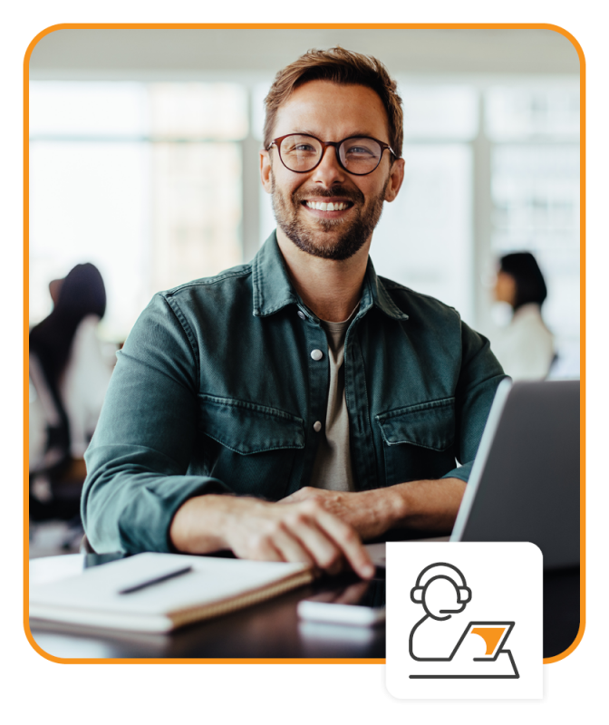 Portrait of a business man sitting in an office with his colleagues in the background.