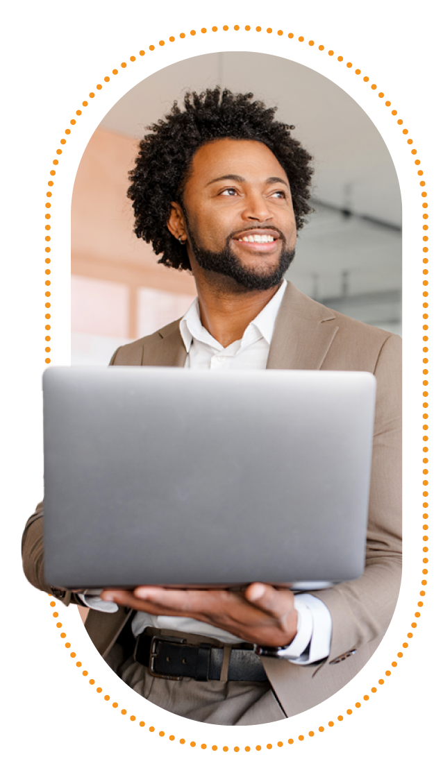 Portrait of a business man on a laptop standing in an office