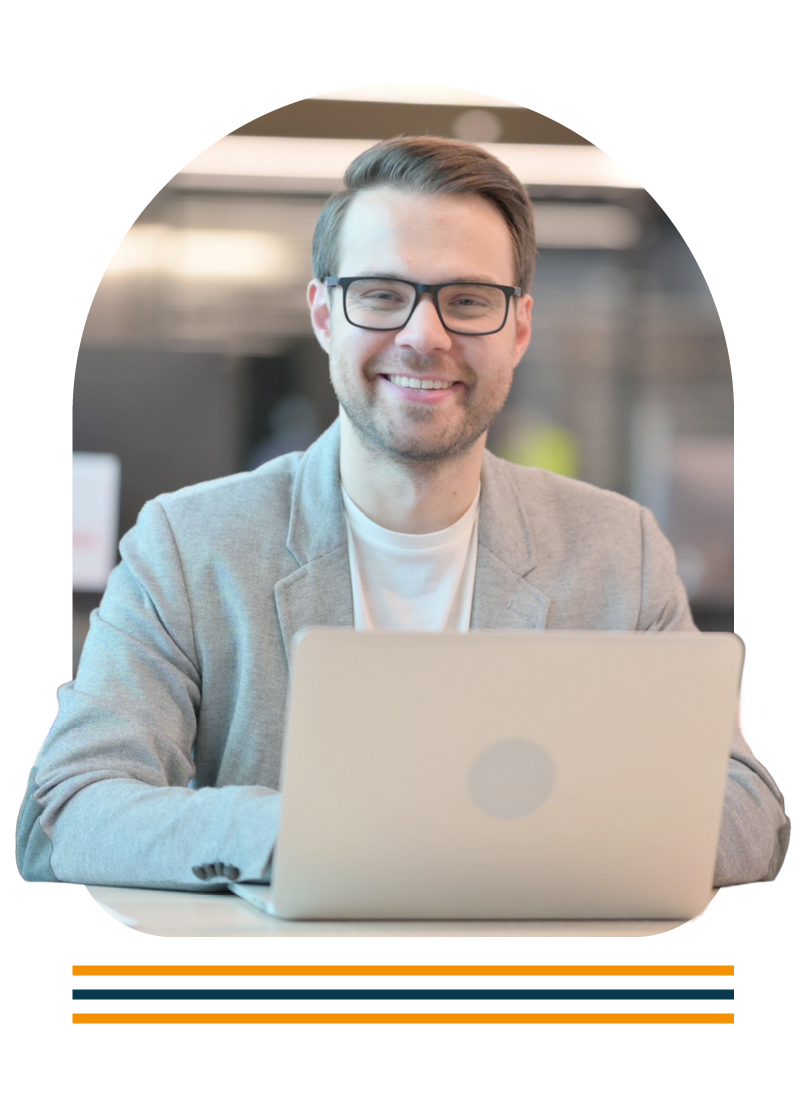 Portrait of a man sat at a desk using a laptop