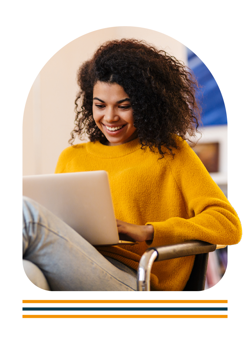 Women smiling while working on a laptop