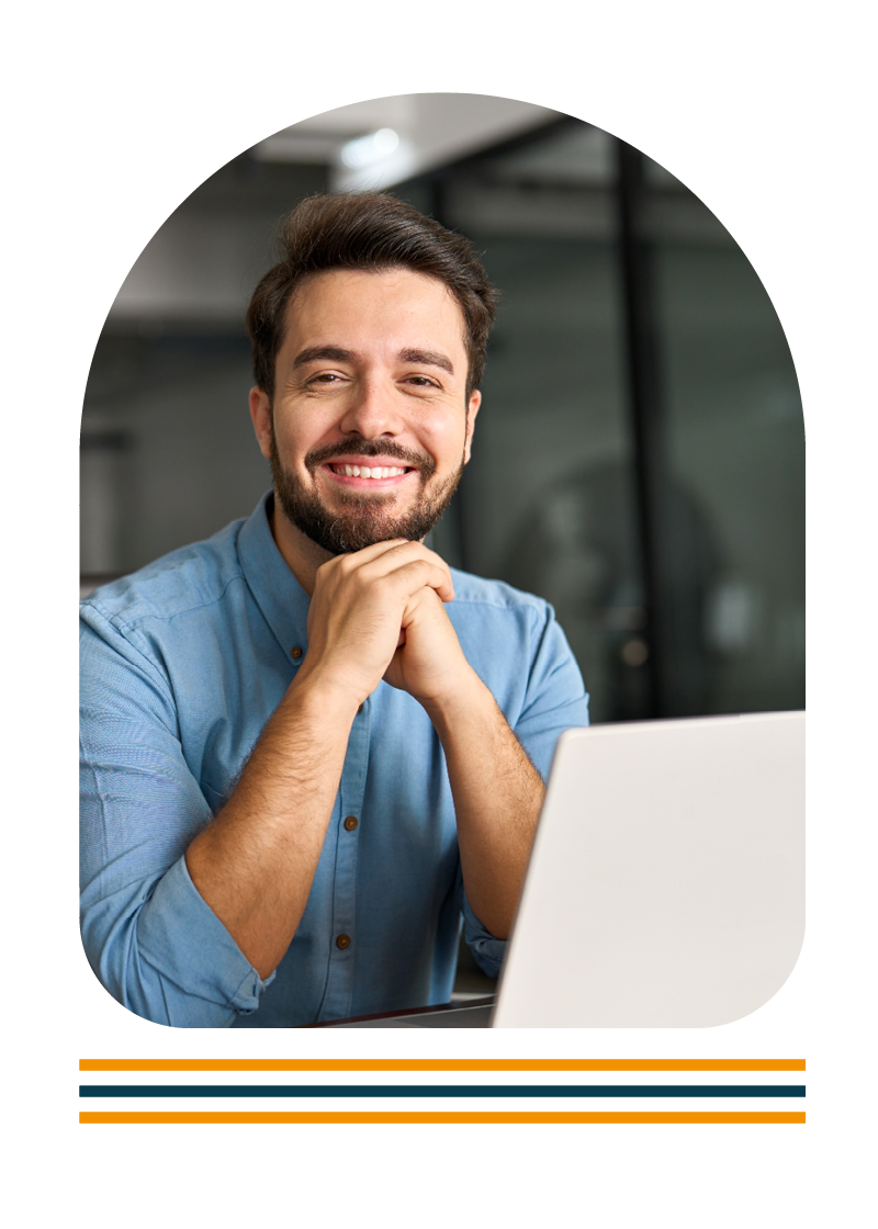 Portrait of a man sat at a desk using a laptop