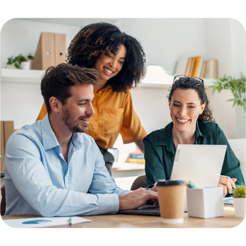 three employees looking at a laptop smiling diverse