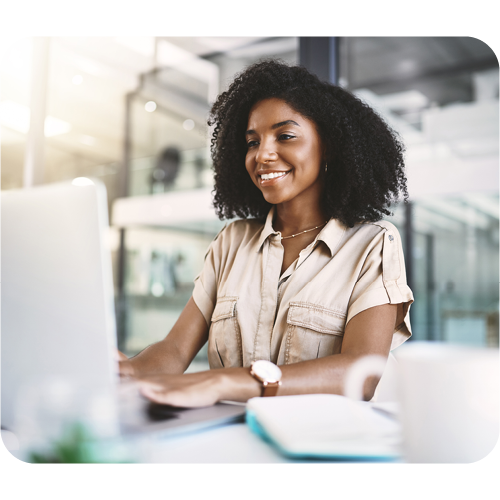 business person woman at laptop modern office smiling