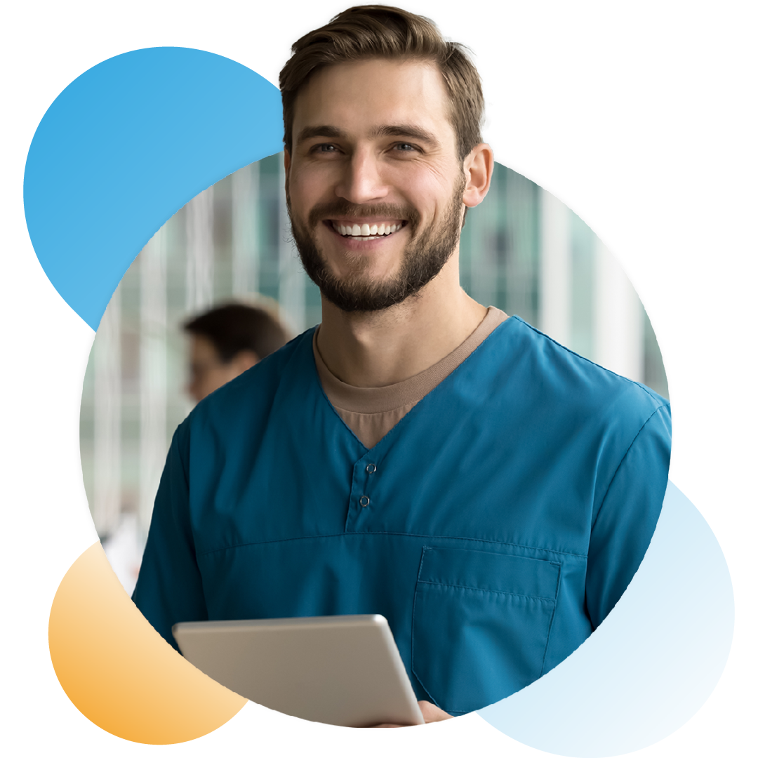 Image of a smiling doctor stood holding a tablet