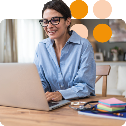 woman working from home in glasses at desk smiling